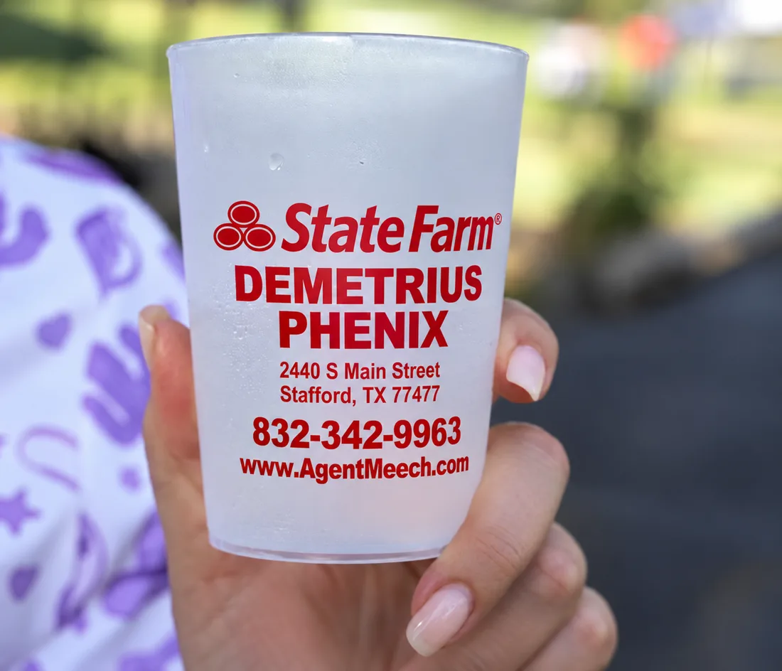 A cup branded with State Farm agent Demetrius Phenix's name, address and phone number