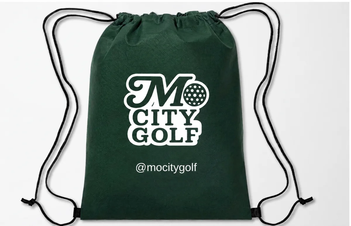 Dark green Mo City Golf drawstring swag bag with the @mocitygolf handle
